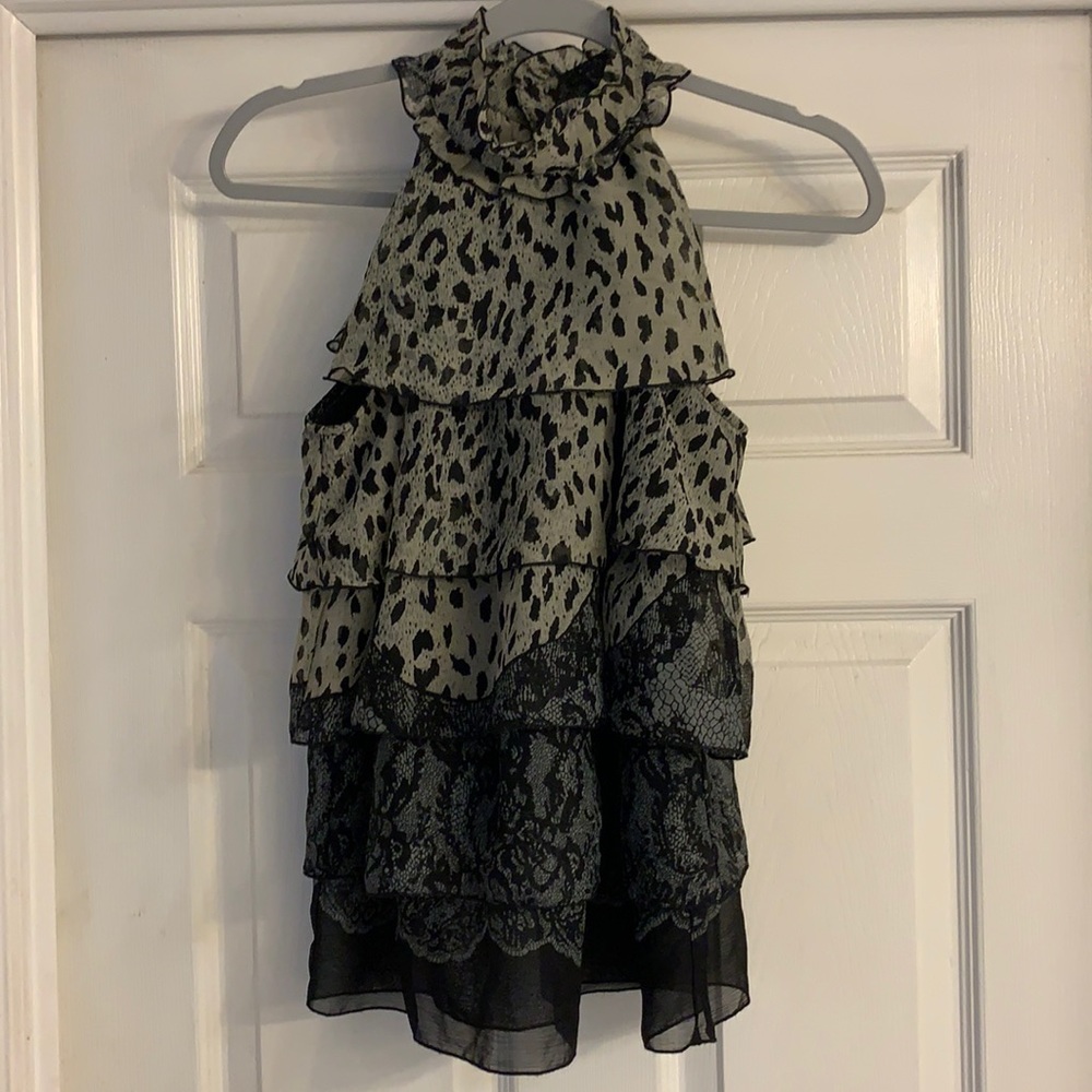 A high collar ruffle sleeveless top.